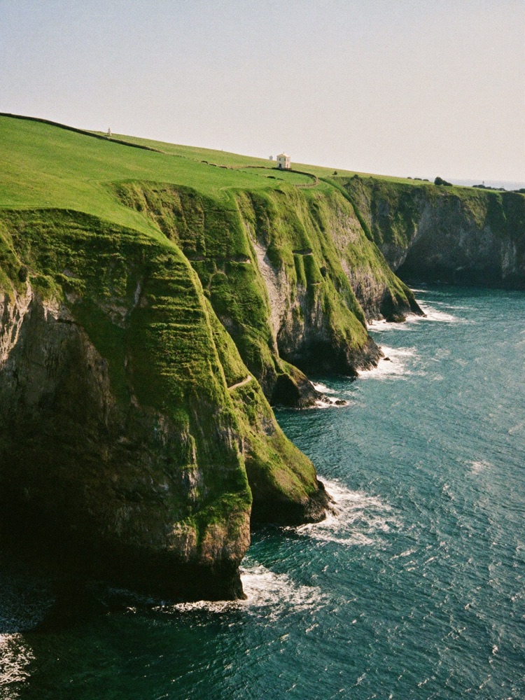 Green cliffs above a turquoise cove on Spain's Atlantic coast