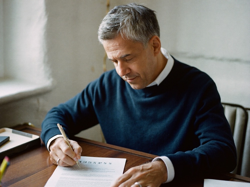 A Viva Mortgages Spain advisor reviewing a mortgage document at his desk