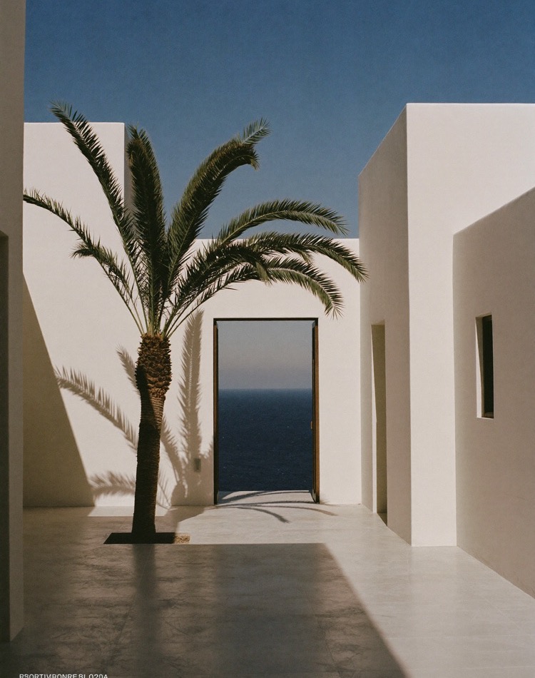 White arched doorway opening onto the Mediterranean